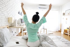 Woman stretching in her room