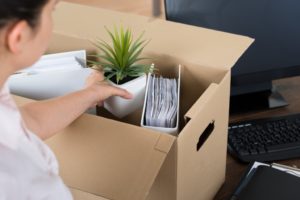 woman putting her things in a box