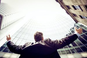 businessman facing commercial buildings